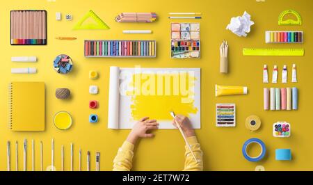Flat lay top view of child hands with school supplies, back to school concept. Stock Photo