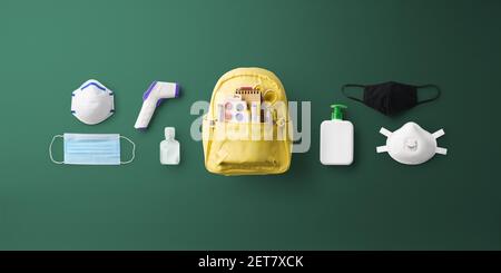 Flat lay top view of face mask and backpack, back to school and coronavirus concept. Stock Photo