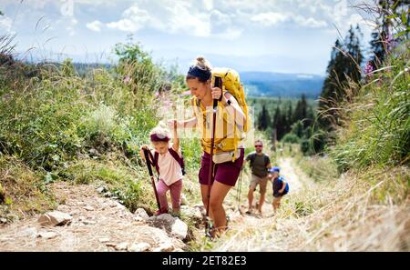 Family with small children hiking outdoors in summer nature, walking in High Tatras. Stock Photo