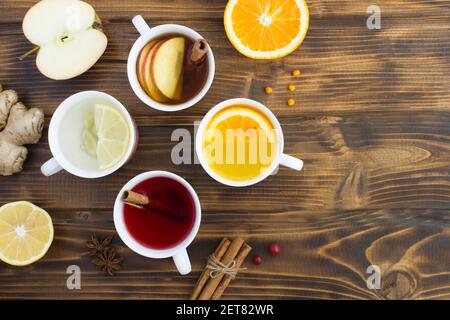 Top view of different teas in the white cups on the wooden background Stock Photo