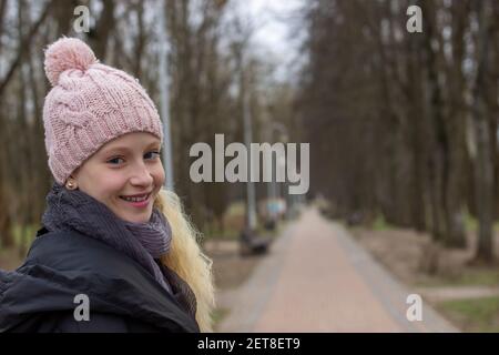 portrait of a teenage girl with blond hair in an early spring park Stock Photo