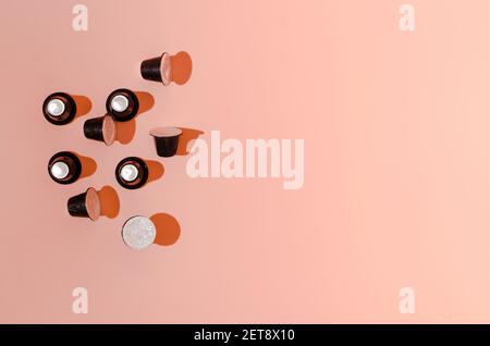 Coffee capsules on a pastel pink background. Minimal creative design. Food and drinks concept. Flat lay. Copy space. Stock Photo