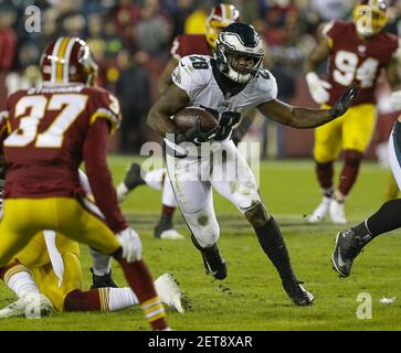 Washington Redskins RB Wendell Smallwood (34) is tackled by San Francisco  49ers DB Jimmie Ward (20) in the second quarter of a game at FedEx Field in  Landover, Maryland on October 20