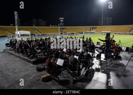 Erbil, Iraq. 01st Mar, 2021. Members of a Kurdish Christian choir and Orchestra take part in a rehearsal at Erbil's Franso Hariri Stadium, in preparation for the visit of Pope Francis to Kurdistan. Pope Francis is scheduled to hold a mass at the stadium of the Kurdish capital as part of his trip to Iraq from 05 to 08 March 2021. Credit: -/dpa/Alamy Live News Stock Photo