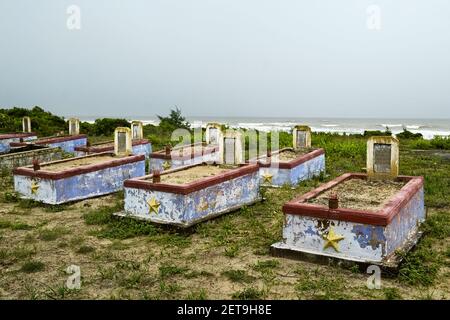 Cemetery of the Vietnam War with old weathered  tombstones near a beach in Lang Co Stock Photo