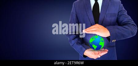Environmental Concept Backdrop Design with Man Holding a Globe in Green and Blue Color Stock Photo