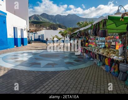 Puerto de las Nieves, Agaete, Gran Canaria, Canary Islands, Spain December 17, 2020: Street market stands with souvenires and clothes at small fishing Stock Photo