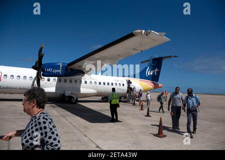 passengers disembarking from liat aircraft at grantley adams  international airport seawell christ church barbados windward islands west indies Stock Photo