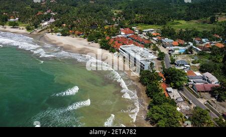 Aerial view of Karang Bolong Beach and Its Wonderful Sunset View. At anyer beach with noise cloud and cityscape. Banten, Indonesia, March 3, 2021 Stock Photo