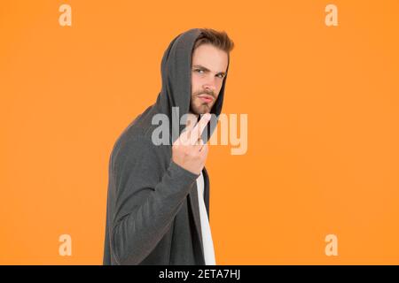 Rude and bad. Rude guy show middle finger yellow background. Rude hand ...