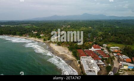 Aerial view of Karang Bolong Beach and Its Wonderful Sunset View. At anyer beach with noise cloud and cityscape. Banten, Indonesia, March 3, 2021 Stock Photo