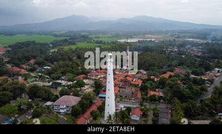 Aerial view of Lighthouse sea rock sunset landscape. Sunset lighthouse scene. At anyer beach with noise cloud and cityscape. Banten, Indonesia, March Stock Photo