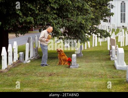 1980s ELDERLY MAN VISITING GRAVE SITE STANDING BY HEADSTONE IN CEMETERY PRAYING LOOKING DOWN AT RED IRISH SETTER DOG - cc001058 CAM001 HARS OLD AGE DEATH MARKER AGING CANINES CAM001 RESPECT HEADSTONE FEELING GRAVEYARD POOCH IRISH SETTER CONNECTION CONCEPTUAL COMPANION LONELINESS VISIT VISITING ELDERLY MAN LOVED ONE PERSONAL ATTACHMENT AFFECTION CANINE EMOTION EMOTIONAL EMOTIONS GRAVE GRIEF MAMMAL TOGETHERNESS WIDOWER CAUCASIAN ETHNICITY CEMETERY GRAVES OLD FASHIONED REMEMBRANCE TOMBSTONES Stock Photo