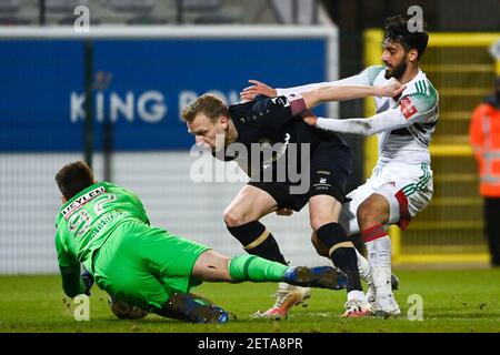 Antwerp's goalkeeper Ortwin De Wolf, Antwerp's Ritchie De Laet and OHL's Mousa Tamari fight for the ball during a soccer match between OH Leuven and R Stock Photo