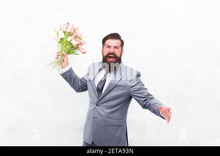 Nice bouquet. stay romantic at any season. man presenting flowers. mothers day. Waiting for his girlfriend. man in jacket holding bouquet of flowers. tulips for womens day. happy birthday concept. Stock Photo