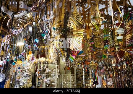 interior of a handmade jewelry store with bracelets, necklaces, pendants, bracelets, hairpins and other hanging articles Stock Photo