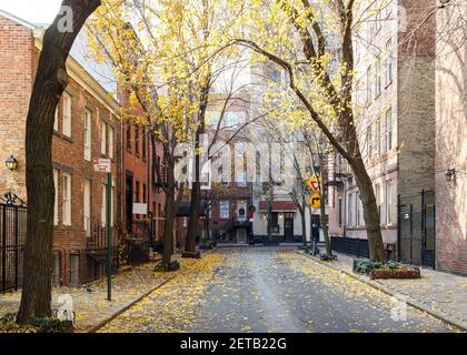 Colorful fall trees line Commerce Street in the historic West Village neighborhood of Manhattan, New York City NYC Stock Photo