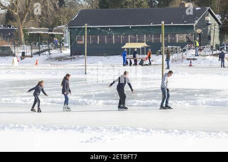 ZUTPHEN, NETHERLANDS - Feb 14, 2021: People of various ages ice skating on an outdoor skating rink Stock Photo