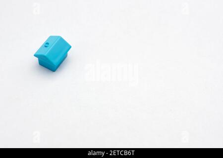 Real estate buy sell house icon property building home improvement. Miniature home on white paper document background business property contract. One Stock Photo
