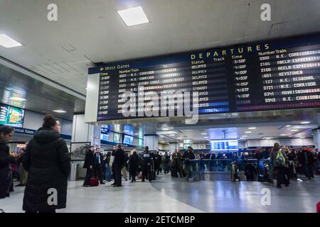 Travelers for Amtrak and NJ Transit in Penn Station in New York on Monday, January 23, 2017 wait by the departure board. Amtrak will be removing the departure board in Penn Station this evening replacing it with a digital board. Digital displays have already been placed around the station in an effort to alleviate congestion. Because of the N'orEaster train service on Amtrak has been severely disrupted with many trains cancelled. (Photo by Richard B. Levine) *** Please Use Credit from Credit Field ***
