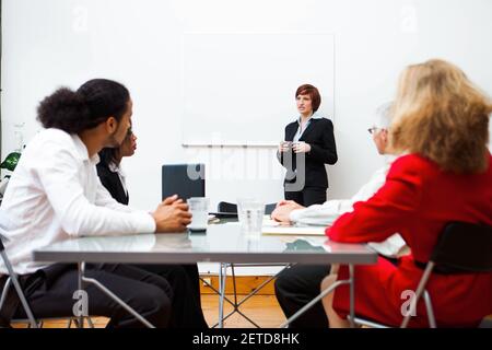Woman giving a presentation with a white board. Stock Photo