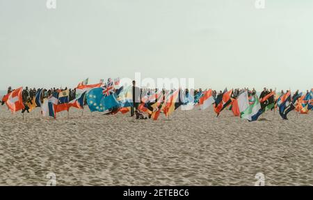 VENICE, UNITED STATES - May 16, 2017: Photo of various country flags on white sand taken at Venice Beach, California. Stock Photo