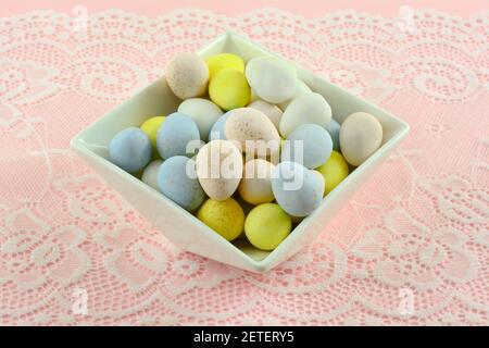 Pastel colored candy Easter eggs in white dessert bowl Stock Photo