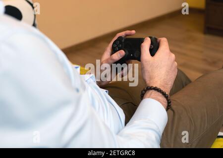 Hand hold modern joystick manipulator. Gamer play game with gamepad controller. Close up Stock Photo