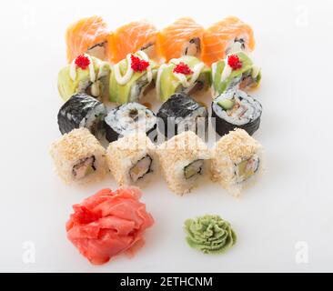 Delicious sushi rolls set with wasabi and marinated ginger. On a table as a background. Stock Photo