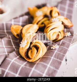 Delicious Palmiers with chocolate on wooden background. Easter concept, bunny Stock Photo