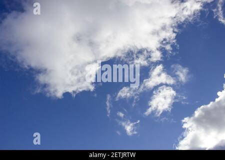 Cloudy day, white clouds in the blue sky, scattered clouds. Stock Photo