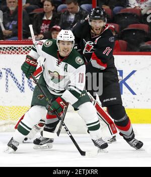 Minnesota Wild's Zach Parise, front left, attempts a shot on-goal which is  blocked by St. Louis Blues goalie Brian Elliott, right, as Blues' Alexander  Steen, back left, helps defend the net in