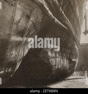 An old  circa WWII press photo showing the British ship (oil tanker)  M.V. BRITISH EARL in dry dock at Sniths Dock with a large hole in its hull caused by hitting a mine at sea. She was built by Armstrong, Whitworth & Co Ltd of  Newcastle upon Tyne in the Low Walker Yard in 1901 ( Launched: 08/12/1900 Completed: 01/03/1901) . Originally named the Pinna, she was  acquired in 1917, sold to Italy 1929 and scuttled in 1940 . She was   refloated and taken over by the US Government with a new name  Orissa, The vessel was scrapped in  1950 having also been named Tankschindler, Trottiera & Malvern Stock Photo