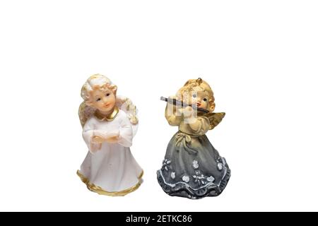 Angel figurines of a girl with a flute and a boy isolated on a white background Stock Photo