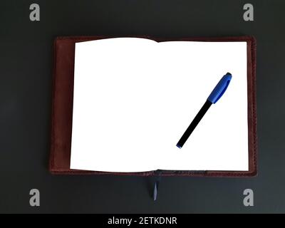 Notepad and pen on black isolated background with mockup Stock Photo