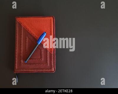 Notepad and pen on black isolated background. Stock Photo