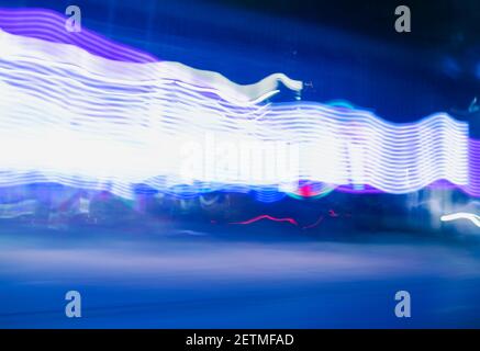 City colorful night lights perspective blurred by high speed of the car. A streak of light, trails. Stock Photo