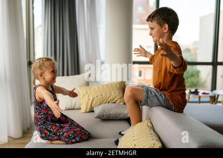 Little kids, siblings hug and cuddle at home show love and care. Family children support concept Stock Photo