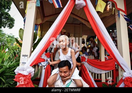 (170405) -- MAE HONG SON, April 5, 2017 (Xinhua) -- Boys are carried away by their relatives after hair-shaving at Wat Pang Lo during the Poi Sang Long novice monk ordination rituals in northern Thailand's Mae Hong Son, March 31, 2017. Considered as one of the biggest moments in a boy's life, the Poi Sang Long novice monk ordination rituals are held every year by the Shan peoples, also known as the Tai Yai, who mainly dwell in Myanmar and northern Thailand. Aged between 7 and 14 years old, the boys, called 'Sang Long' in the Shan language, will undergo a series of ritual procedures during a ty