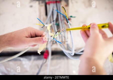 Pro electrician demonstrating a high degree of skill and competence in electrical work Stock Photo
