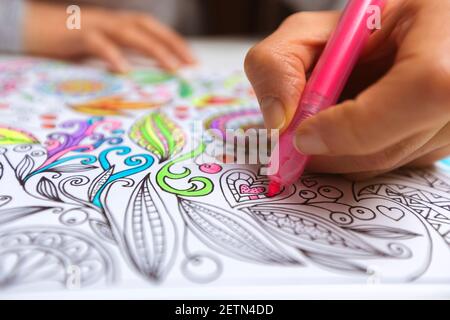 Coloring book for adults. Drawing as a hobby. Concentration activities to relieve stress. Stock Photo