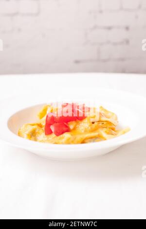 delicious stuffed mezzaluna pasta made from scratch with heirloom tomato sauce Stock Photo