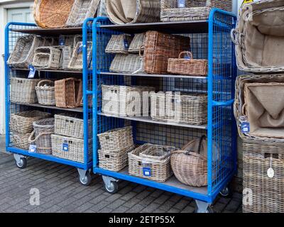 Wicker baskets for sale outside a hardware store, Olney, Buckinghamshire, UK Stock Photo