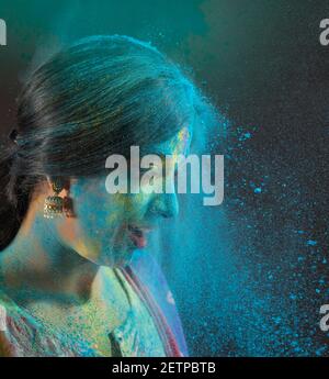 PORTRAIT OF A WOMAN BEING THROWN COLOUR AT DURING HOLI Stock Photo