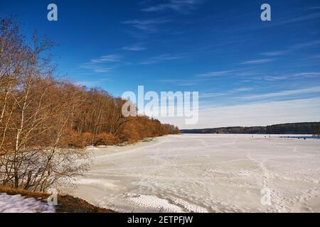 Early Spring With Melting Ice And Snow. Nature in March. Lake and forest rural scene. Belarus river Vyacha Stock Photo