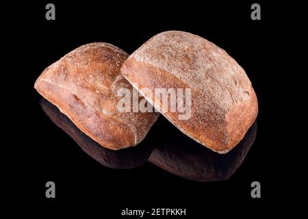 Freshly baked homemade bread isolated on black. Italian ciabatta bread. Healthy eating and traditional bakery, baking bread concept Stock Photo
