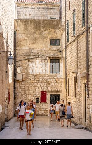 Dubrovnik, Croatia - Aug 20, 2020: Tourists walk in old town street in summer Stock Photo