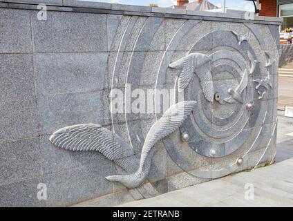 Stone relief sculpture showing sea birds and cirles on the promenade at Hornsea in East Yorkshire Stock Photo