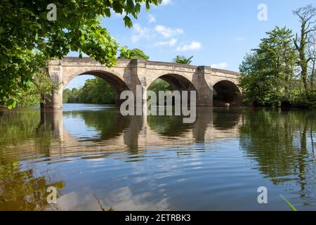 Summer view of the old stone bridge over the River Ure at Masham in North Yorkshire Stock Photo