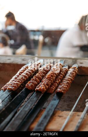 Traditional Turkish grilled shish kebab or kebap. Delicious Adana kebab on black background. Stock Photo